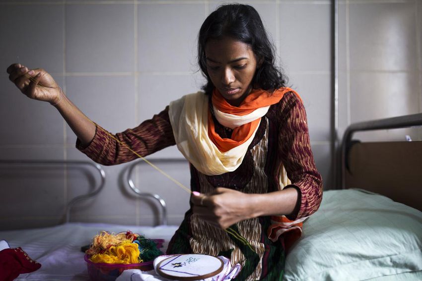 Popi Rani Das stitches to pass the time at the Acid Survivors Foundation Hospital in Dhaka, Bangladesh, in 2016, where she lived for seven years until coming to Canada for surgery.