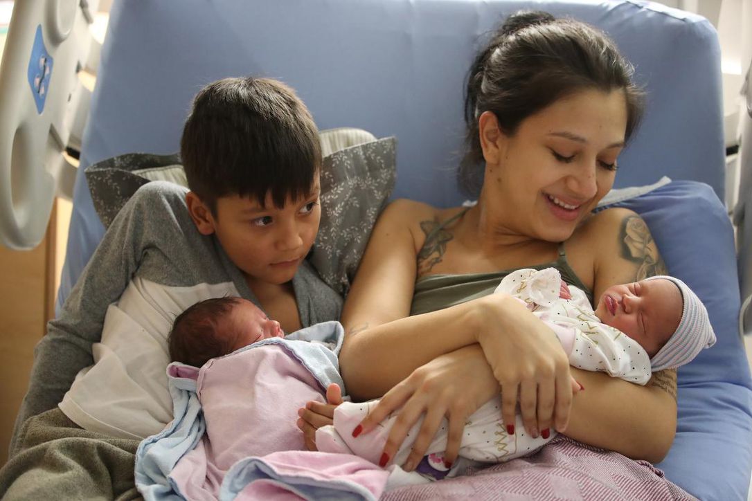 Melissa Arrubla and Anderson, 7, hold Elian and Elena.