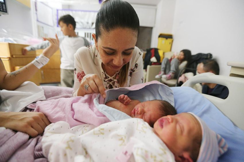 Grandmother Liliana Arrubla looks over her newest grandchildren Elian and Elena.