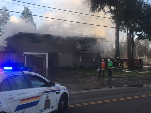 Surrey fire crews battle large house fire – BC